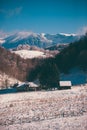 Ancient romanian houses on the frozen hills in the middle of winter