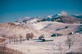 Ancient romanian houses on the frozen hills in the middle of winter