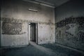 An ancient room with a door in an old abandoned house. Shabby and dirty walls. Royalty Free Stock Photo