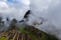 Macchu Picchu before sunrise covered in rising clouds