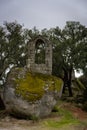 Ancient ruin stone structure building covered with moss near Sao Pedro chapel with trees and boulder landscape in Monsanto, Royalty Free Stock Photo