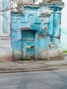 Ancient ruined blue building. Destroyed cyan house. Travel street photo. Turquoise weathered wall