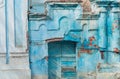 Ancient ruined blue building. Destroyed cyan house. Travel street photo. Turquoise weathered wall