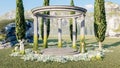 Ancient ruined Greek Roman stone gazebo in meadow and flowerbed with empty stage for mockup, 3d rendering