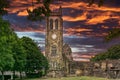 The Old Clock Tower Ruins at KIlwinning Abbey at the end of the day in front of a dramatic red Sky