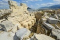 Ancient ruins near the Parthenon on Acropolis Hill with Lykavittos Hill in the distance, in Athens, Greece