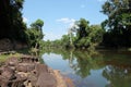 Ancient ruins on the river bank. A small muddy river. Landscape