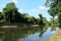 Ancient ruins on the river bank. A small muddy river. Landscape