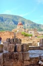 Ancient ruins in the Simat de la Valldigna Monastery under the sunlight and a blue sky with a mountain at the back