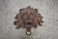 Ancient rustic steel iron crafting of lion head statue with Wall brick stone sculpture, old historical door bell