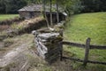 Ancient rustic stone made house and a fence in the woods