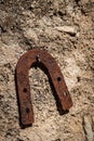 Ancient rusty horsehoe hanging on stone wall Royalty Free Stock Photo