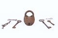 Ancient rusty padlock with collection of keys isolated on white background Royalty Free Stock Photo