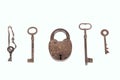 Ancient rusty padlock with collection of keys isolated on white background Royalty Free Stock Photo