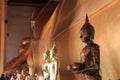 The ancient and sacred Buddha statues are black and are covered with gold plates in the temple