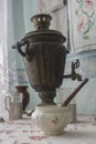 Ancient samovar on a table for tea drinking 2
