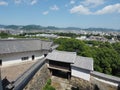 Ancient samurai castle in Himeji city in Japan with white walls, dark tile roofs and stone walls on a sunny day in summer with blu Royalty Free Stock Photo