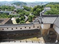 Ancient samurai castle in Himeji city in Japan with white walls, dark tile roofs and stone walls on a sunny day in summer with blu Royalty Free Stock Photo