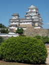 Ancient samurai castle in Himeji city in Japan with white walls, dark tile roofs and stone walls on a sunny day in summer with blu Royalty Free Stock Photo