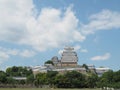 Ancient samurai castle in Himeji city in Japan with white walls, dark tile roofs and stone walls on a sunny day in summer with blu Royalty Free Stock Photo