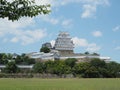 Ancient samurai castle in Himeji city in Japan with white walls, dark tile roofs and stone walls on a sunny day in summer with blu Royalty Free Stock Photo