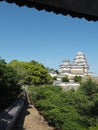 Ancient samurai castle in Himeji city in Japan with white walls, dark tile roofs and stone walls on a sunny day in summer with blu Royalty Free Stock Photo