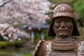 ancient samurai warrior statue in spring garden Royalty Free Stock Photo