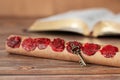 Ancient scroll with seven seals with old key on wooden table with holy bible book in the background