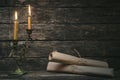 Ancient scrolls and burning candle. Royalty Free Stock Photo