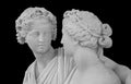 Ancient sculpture of Bacchus and Ariadne. Marble man and woman statue isolated on black background. Royalty Free Stock Photo