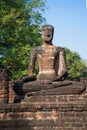 Ancient sculpture of a seated Buddha on the ruins of the Buddhist temple Wat Singha. Kamphaeng Phet, Thailand