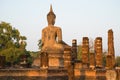 Ancient sculpture of a seated Buddha on the ruins of the temple Wat Chana Songkhram. The view from the back. Sukhothai, Thailand Royalty Free Stock Photo