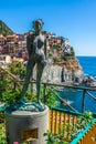 Ancient sculpture and view of Manarola. La Spezia, Liguria, nor