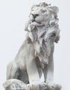 Ancient Sculpture of White sitting Coade stone Lion isolated on white backgrounds, clad strong statue, leadership symbol monument Royalty Free Stock Photo