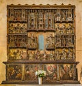 An ancient sculptured and painted reredos with many wooden figures