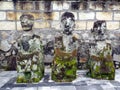 Ancient sculptures of three kings made of stone in a cemetery of Lake Toba, Pulau Samosir. Indonesia
