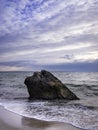 Ancient Sea Rock on the Beach under Dramatic Clouds Royalty Free Stock Photo