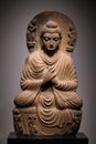 Ancient seated Buddha schist statue image in 2nd-3rd century, Kushan dynasty from Gandhara, Pakistan