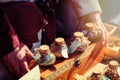 Ancient shop of a seller of spices at the historic fair. The hands of the seller of spice on the retro market Royalty Free Stock Photo