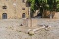 Very old source of water on the medieval square of Argyrokastro. Rhodes Old Town, Greece