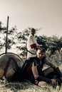 Ancient warrior and woman archer rest near shield and spear Royalty Free Stock Photo