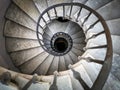 Ancient spiral staircase with decorated wrought iron handrails and marble steps inside an old palace in Rome Royalty Free Stock Photo