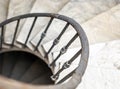 ancient spiral staircase with marble steps and wrought iron handrail Royalty Free Stock Photo