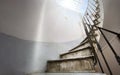 Ancient spiral staircase with marble steps and wrought iron handrail Royalty Free Stock Photo