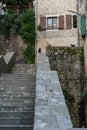 Ancient stairs in Old town Kotor. Medieval stone staircase between apartment buildings in the old town center of Montenegro. Cats Royalty Free Stock Photo