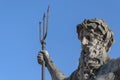 The ancient statue of the god of the seas and oceans Neptune Poseidon. Famous tourist attraction against a blue sky in summer Royalty Free Stock Photo