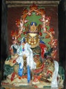 Ancient statue of a golden color Tibetan deity on a mythical animal in a monastery