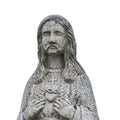 Ancient statue of Jesus Christ. He points a finger at his heart. White background religion, faith concept Royalty Free Stock Photo