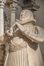 Ancient statue of a praying rich nobleman from middle age aristocracy at magnificent old city Cathedral in Magdeburg, Germany.