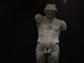 Ancient statue of Priapus symbol of the fertility of ancient Rome isolated on blACk